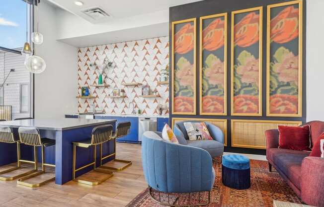 a view of a room with a wall filled with colorful quilts and chairs