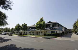 a row of houses on the corner of a street