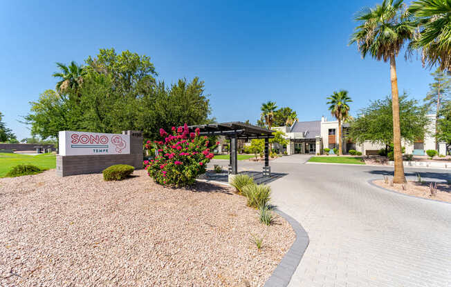 Landscaped entrance to Sono Tempe Apartments in Tempe, AZ with desert-inspired greenery and walkable community paths.