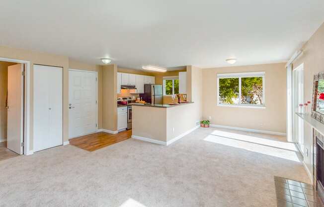 an empty living room with a kitchen and a window at Springfield, Renton