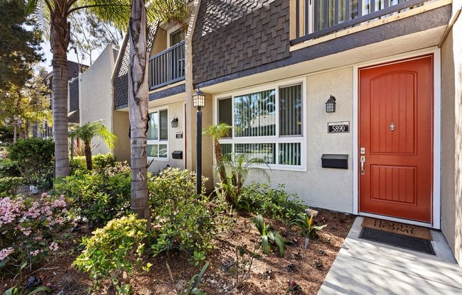 a front entrance to a house with a red door