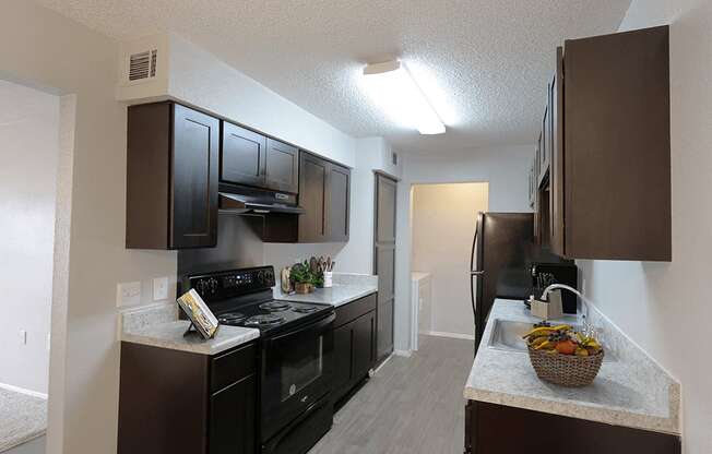 our apartments have a modern kitchen with black appliances and granite counter tops