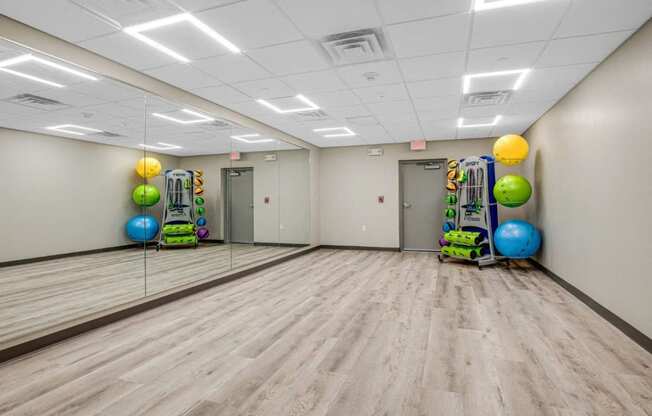 a large room with a dance floor and balls and mirrors