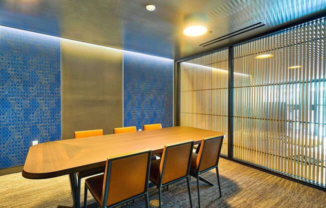 A conference room with a long table and chairs.
