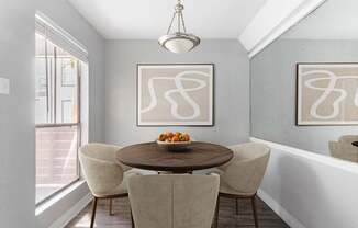 a dining room with a table and chairs and a window