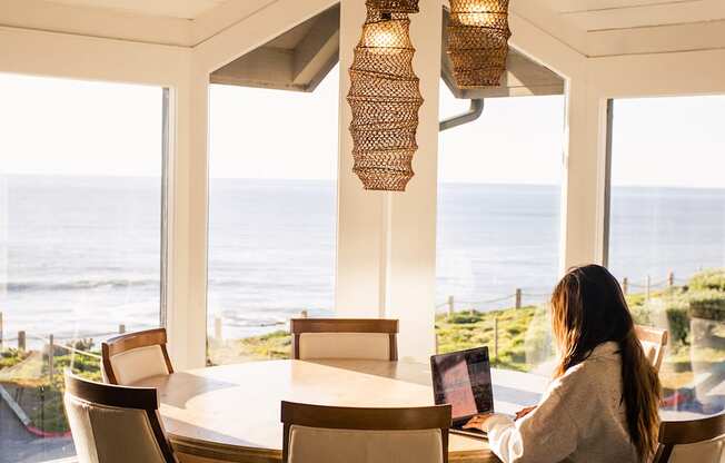 Woman working in the community room at Oceanaire