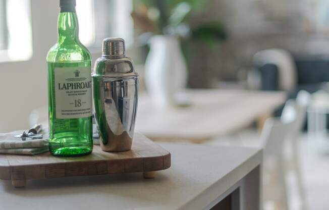 a bottle of liquor and a cocktail shaker sit on a kitchen counter at The 22 Apartments, St. Louis Missouri