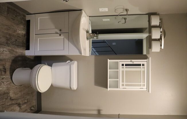 an overhead view of a small bathroom with a toilet and a sink