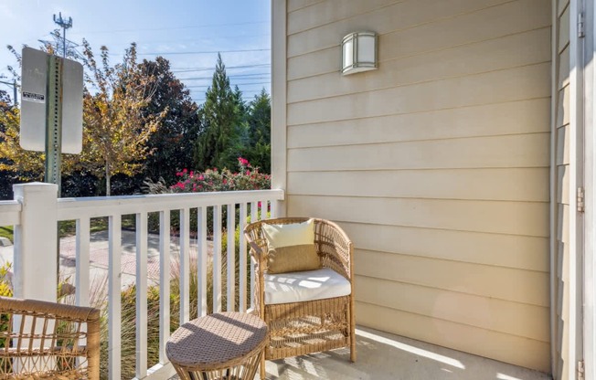 A patio with a chair and a table.at Century Hampton Roads, Suffolk, 23435  
