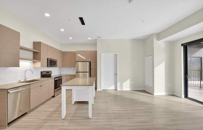 A modern kitchen with a dining table and chairs.