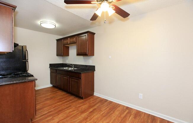 a kitchen with hard wood floors