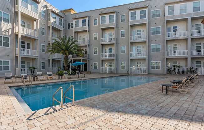 a swimming pool in front of an apartment building