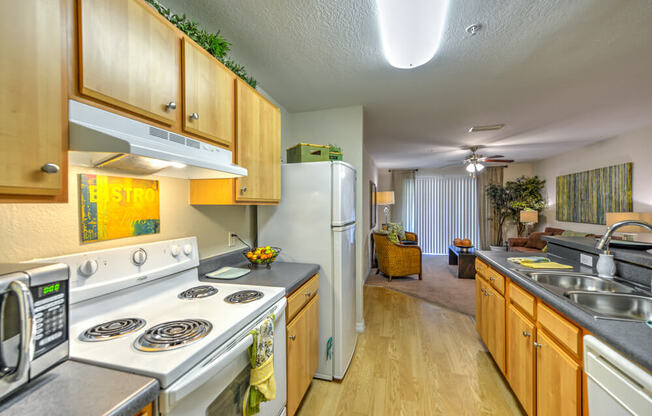 A kitchen with wooden cabinets and a stove top oven.