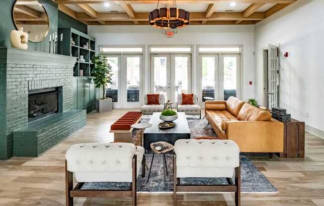 A living room with a green fireplace and a large chandelier.