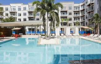Resort pool with palm trees and cabanas at LandonHouse Apartments in Lake Nona, Orlando, FL 32827