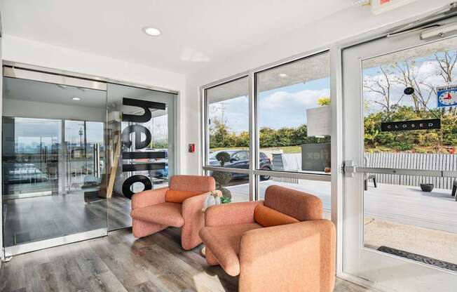 A modern living room with a glass door leading to a balcony.