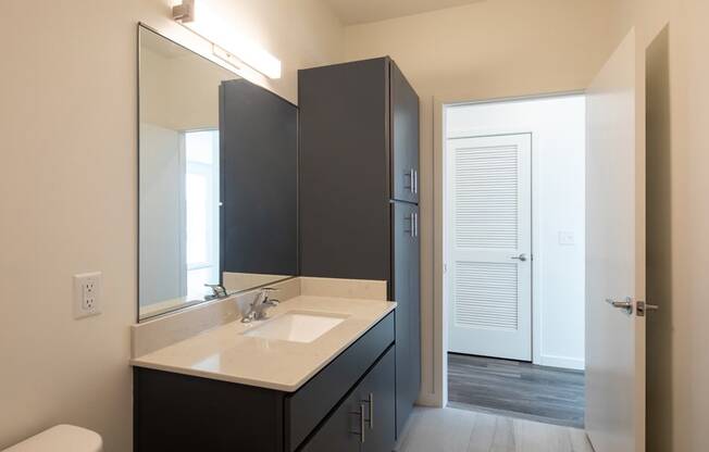 an empty bathroom with a sink and a mirror