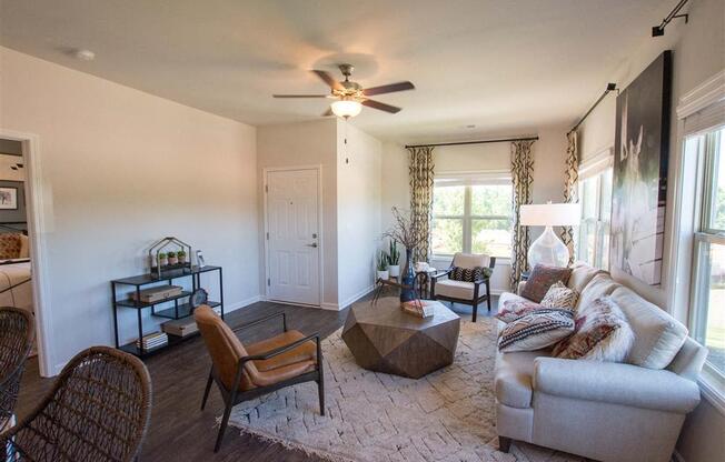 a living room with a couch and a ceiling fan
