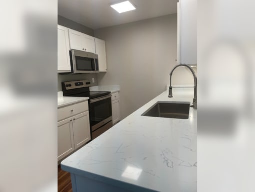 a view of a kitchen with sinks and counters