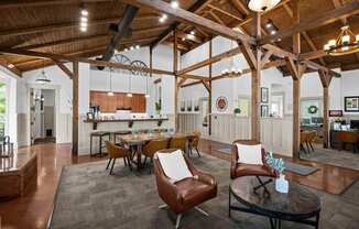 a living room with a table and chairs and a kitchen