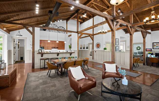 a living room with a table and chairs and a kitchen