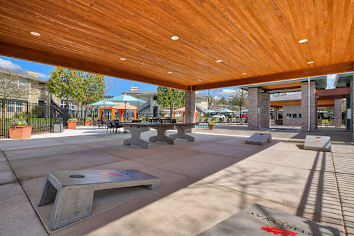 A skate park with a wooden roof and a skateboard ramp.