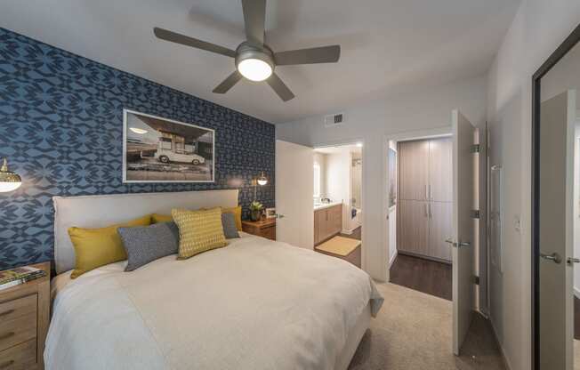 a bedroom with a large bed and a ceiling fan