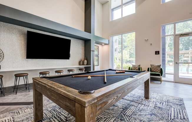 our apartments have a game room with a pool table and flat screen tv at Century University City, Charlotte, 28213