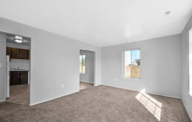 Open-concept living room with dining area and kitchen at Farmbrooke Manor Clinton Township MI