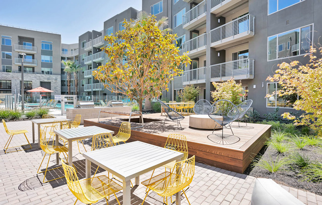 an outdoor patio with tables and chairs