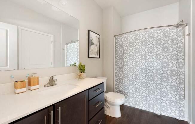 A bathroom with a white sink and a toilet.