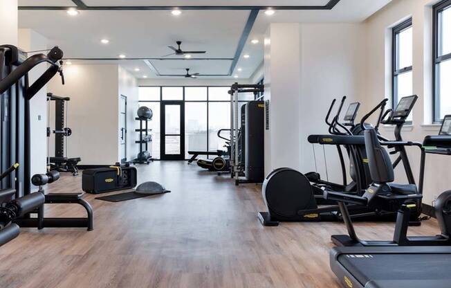 24/7 fitness studio with Technogym cardio, spin, rowing, bench & weight stations