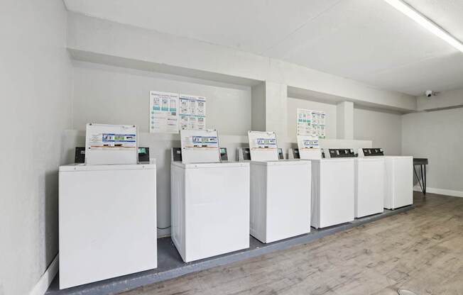 A series of white boxes are lined up in a room.