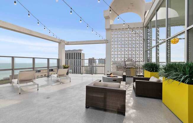Rooftop sun deck with fire pit and grilling station