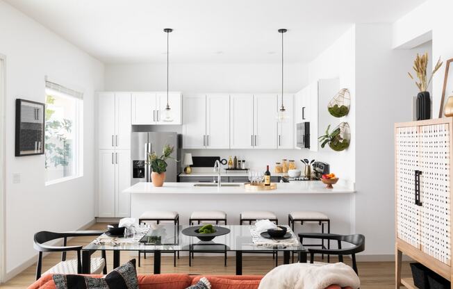 a kitchen and living room with a table and chairs