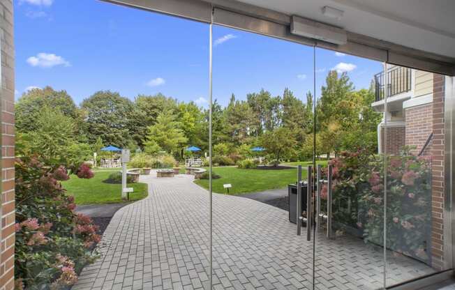 a view of a courtyard from a glass door