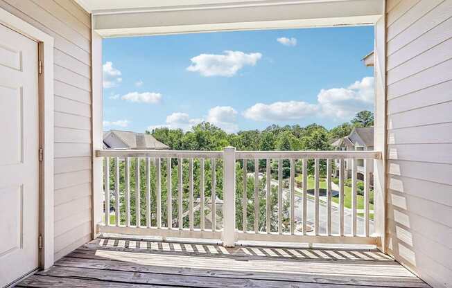 A view from a porch looking out at a residential neighborhood.