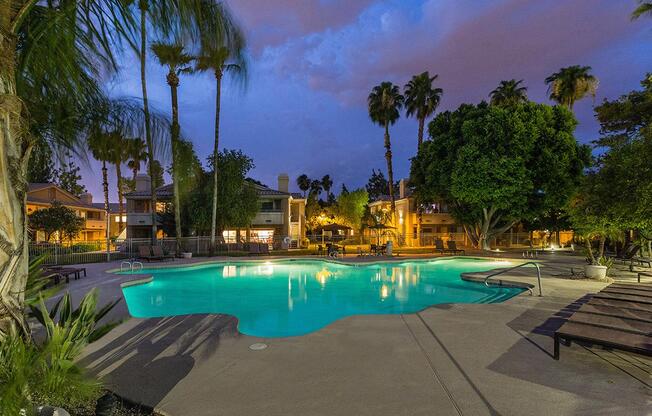 a group of palm trees next to a pool of water