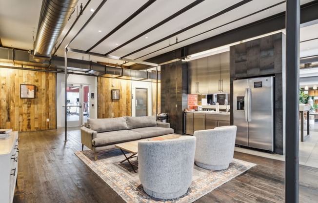 a living room with a couch and chairs and a kitchen at Bakery Living, Pittsburgh, PA