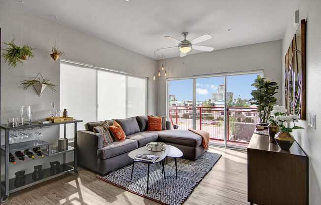 a living room with a couch coffee table and a ceiling fan