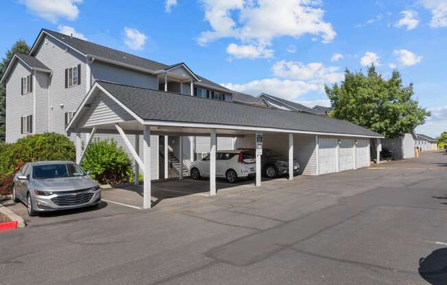 the parking lot of a motel with cars in front of it