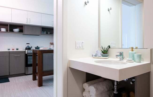 A bathroom with a sink and mirror.