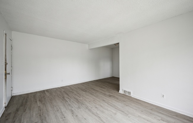 A room with a wooden floor and white walls.