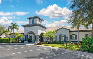 A white building with a tower and a sign that says