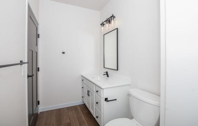 a white bathroom with a white toilet and a white sink at The Crossings at Windsong, Arizona, 86314