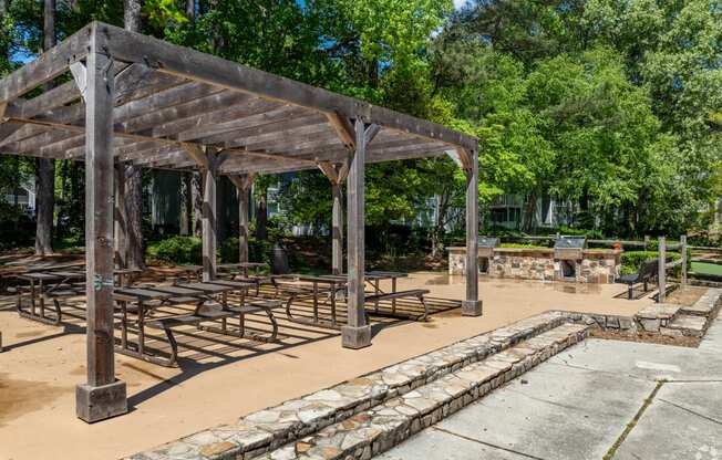 a group of picnic tables under a pavilion in a park