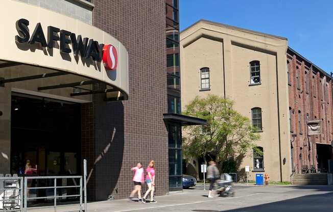 Safeway store with people walking in front.