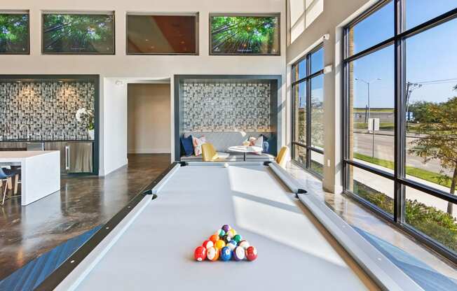 a billiards room with a pool table and a lot of colorful balls