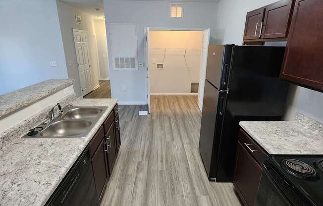 Modern kitchen with a stainless steel sink at The Assembly Apartments, SC 29611,