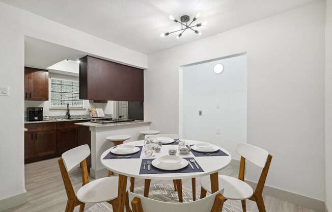 a dining room with a table and chairs and a kitchen